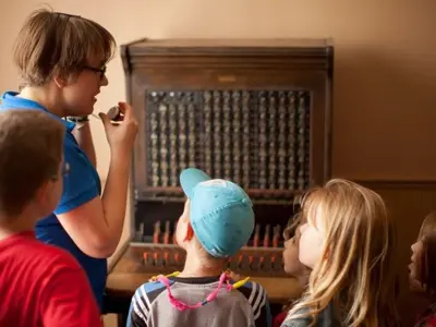 children looking at original phone switchboard