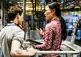 engineer speaks with mechanic on factory floor