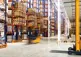loaders move about in a large warehouse