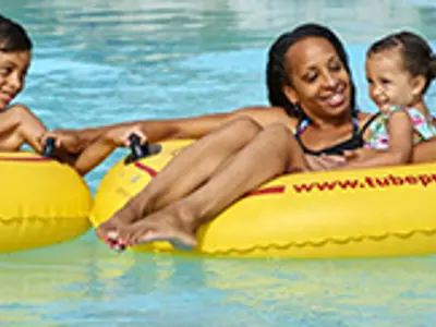 family enjoying a summer afternoon on the lazy river