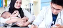 doctor writes a prescription for a mother with infant
